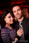 DJ Gina Calderoni hangs on Roger for a pic.